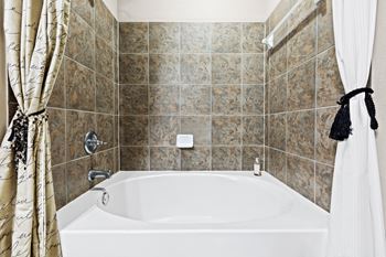 garden style tub with brown tiles